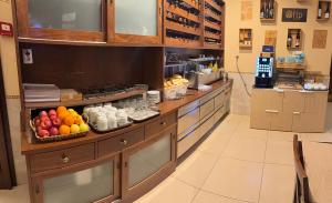 a kitchen with a buffet with fruits and drinks at Aliança Alojamento Local in Guarda