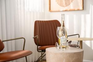 a bottle of wine sitting on a table with a glass at One Apartments TLV in Tel Aviv +89 photos