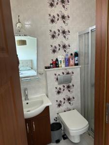 a bathroom with a sink and a toilet and a mirror at Eos in Çeşme +37 photos