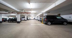 a large parking garage with cars parked in it at PLAZA INN Schmöker-Hof in Norderstedt