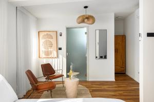 a living room with two chairs and a table at One Apartments TLV in Tel Aviv
