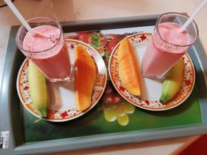two plates of fruit and two drinks on a tray at SiSi Place in Dickwella +42 photos