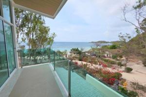 a balcony of a house with a view of the ocean at Ta Yai Beach Resort in Pattaya