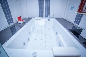 a large white bath tub in a bathroom at Olivier Boutique in Chiang Mai +98 photos