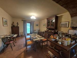 a kitchen with a table and chairs in a room at Agri B&B Ca' Gennara in Porretta Terme