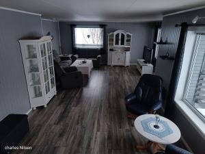 a living room with a couch and a table at Charles Country House in Solstad