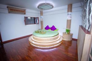 a room with a cake on a wooden floor at Olivier Boutique in Chiang Mai