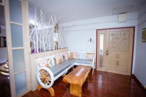 a room with a bench and a wooden table at Olivier Boutique in Chiang Mai