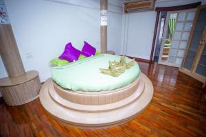 a large white cake sitting on top of a wooden floor at Olivier Boutique in Chiang Mai
