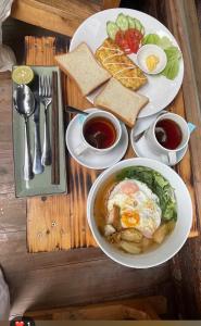 a table with two plates of food with eggs and bread at Wood Haven Homestay in Ninh Binh