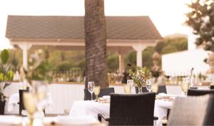 a table with glasses of wine on a patio at DWO Finca Los Abetos in Córdoba