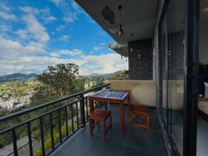 a balcony with a table and two chairs and a view at Climax View Point Inn in Bandarawela