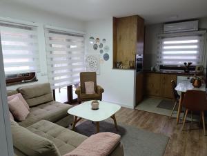 a living room with a couch and a table at Apartman A&E in Živinice