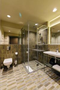 a bathroom with a shower and a toilet and a sink at Guest House Valea Morilor in Chişinău +85 photos