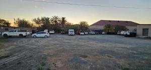 a group of cars parked in a parking lot at Leeu Gamka Hotel in Leeu-Gamka