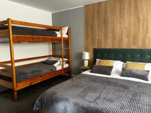 a bedroom with two bunk beds and a bed at Devonshire Lodge Chalet in Bansko +14 photos