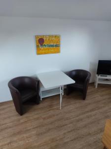 a meeting room with a white table and two chairs at Apartment 10 in Surwold +1 photo