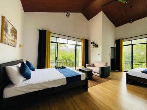 a bedroom with a bed and a chair in a room at Ella White Tea Garden Hotel in Ella
