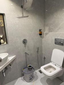 a bathroom with a toilet and a sink at Sahara Inn in Mumbai +19 photos