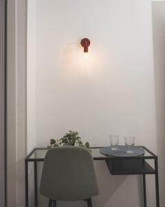 a table with a chair and two glasses on it at Hotel Rural Macondo in Trujillanos