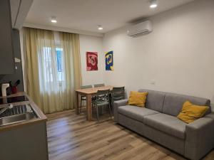 a living room with a couch and a table at Lovely Corner 2 in Porto Santo Stefano