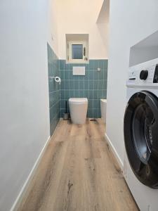a bathroom with a washing machine and a toilet at Lovely Corner 2 in Porto Santo Stefano