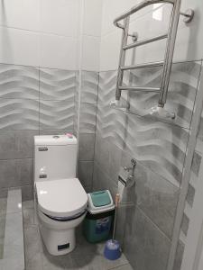 a bathroom with a toilet and a walk in shower at Bobur Guest House in Khiva