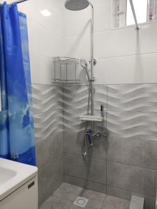a shower with a glass door in a bathroom at Bobur Guest House in Khiva +1 photo