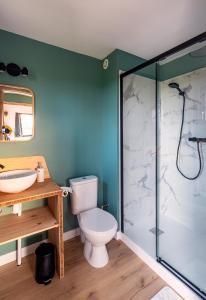 a bathroom with a toilet and a glass shower at Le perchoir in Cuverville +33 photos