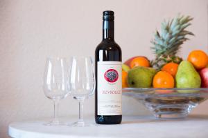 a bottle of wine next to a bowl of fruit at Cave Du Treyblanc in Luins