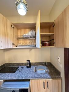a kitchen with a sink and a counter top at Downtown Keys in Hurghada +144 photos