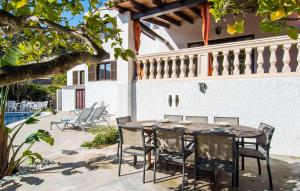 a patio with a table and chairs on a house at Corazon in Canyamel