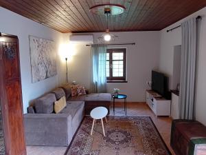 a living room with a couch and a table at Endless View Country House in Makrinitsa