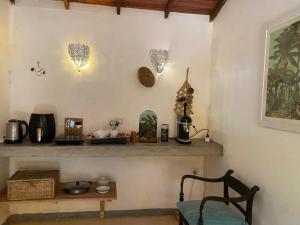 a room with a counter with some items on the wall at Dragon-Fly Home Hikka in Dodanduwa