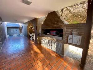 a large living room with a brick fireplace at Gravensteen Urca in Córdoba