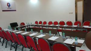 a group of tables and chairs with water bottles on them at Hôtel Résidence Ngary in Thiès