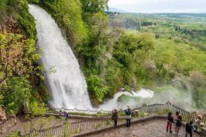a group of people standing in front of a waterfall at Hagiati Guesthouse - Edessa Cozy Mountain Retreat in Edessa