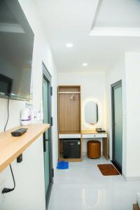 a room with a bathroom with a sink and a mirror at Gia Bảo Hotel Thủ Đức in Ho Chi Minh City +60 photos