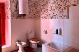 a bathroom with a toilet and a sink and a tub at Hacienda Don Rodrigo in Alcalá de Guadaira +27 photos
