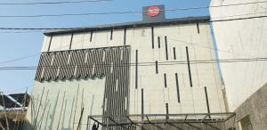 a tall building with a gate on the side of it at Hotel The Coal in Alīgarh