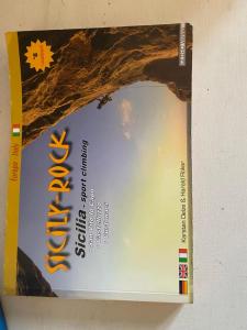 a book with a picture of the sky on it at Villa Corallina Relais & Climbing Center in San Vito lo Capo