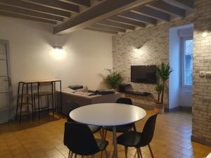 a living room with a table and chairs and a couch at Appartement in Noyen-sur-Sarthe