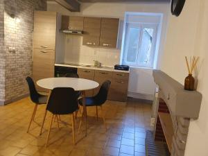 a kitchen with a table and chairs in a room at Appartement in Noyen-sur-Sarthe