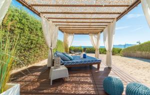 a patio with a bed and a pergola at Sa Platja in Playa de Muro
