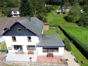an aerial view of a white house with a roof at Ferienhaus im Wiesengrund in Simmerath
