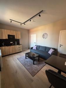 a living room with a blue couch and a table at Modern apartment - Lier in Lier
