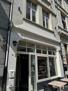 a white building with a table in front of it at Modern apartment - Lier in Lier