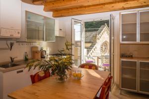 a kitchen with a wooden table and a dining room at Casa Di Mezzo by Arbaspàa in Manarola