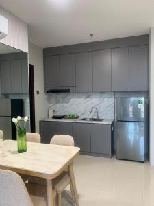 a kitchen with a table and a sink and a refrigerator at Skyline Z in Mantaak