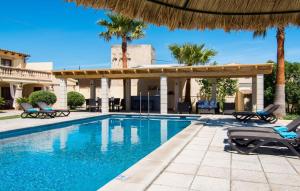 a swimming pool with chairs and a pavilion at Catalina in Alcudia +44 photos